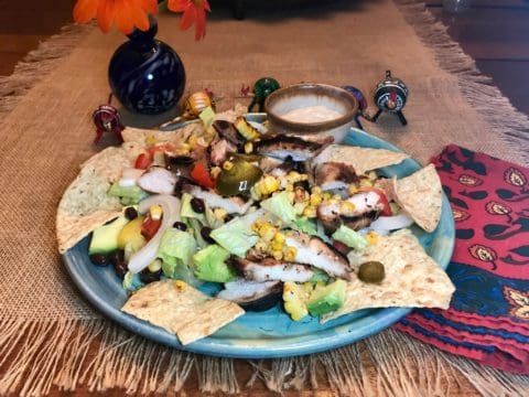 Chicken and corn salad on tortilla chips.