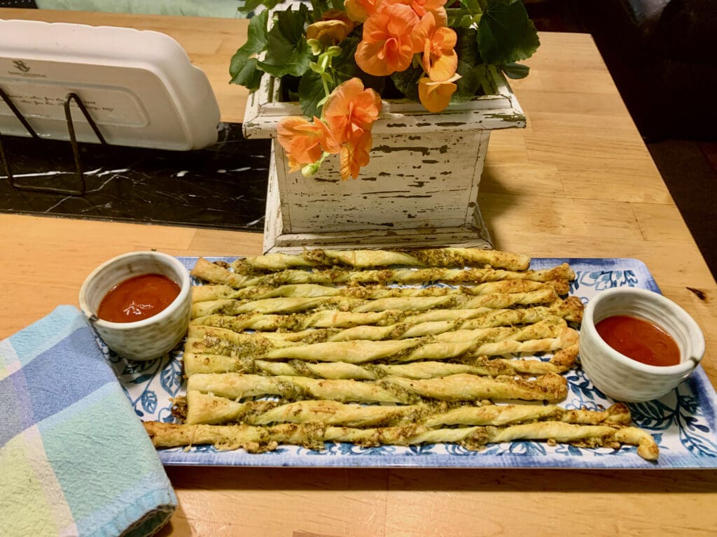 Pesto breadsticks with dipping sauce.