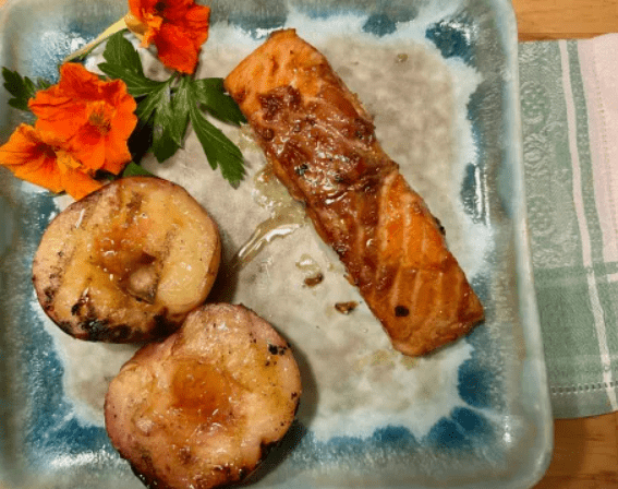 A plate of food with salmon and potatoes.