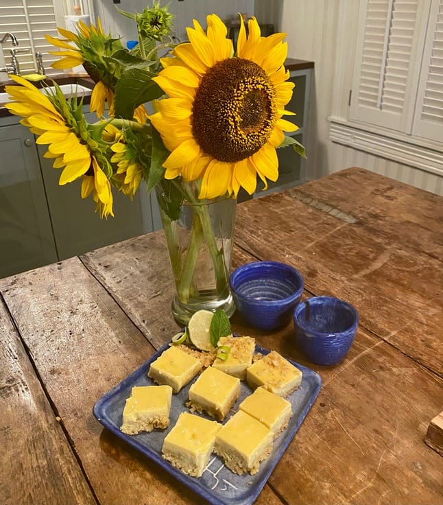 A table with some food and a vase of flowers