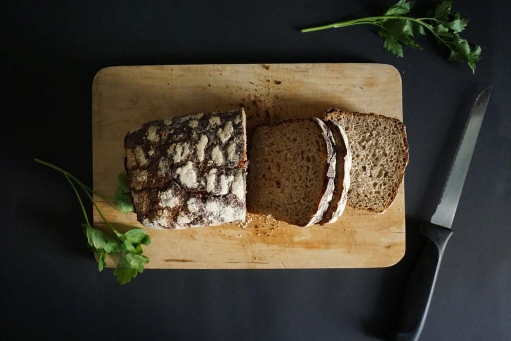 A loaf of bread with a cut in half.