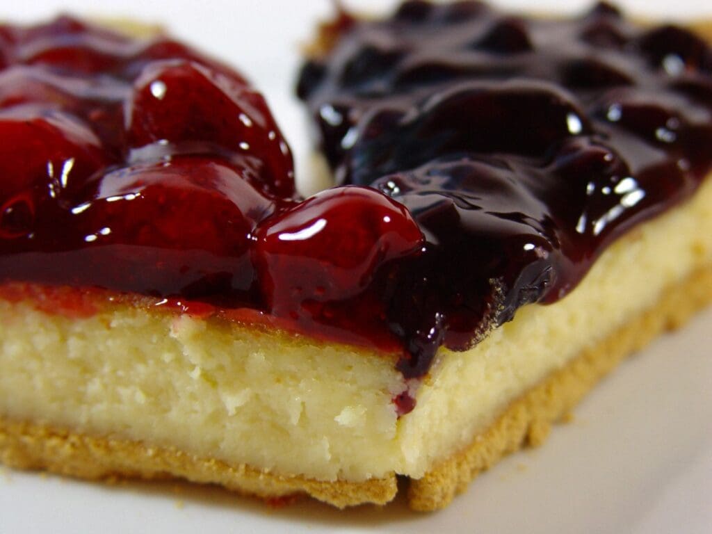 A piece of cheesecake with berry topping on top.