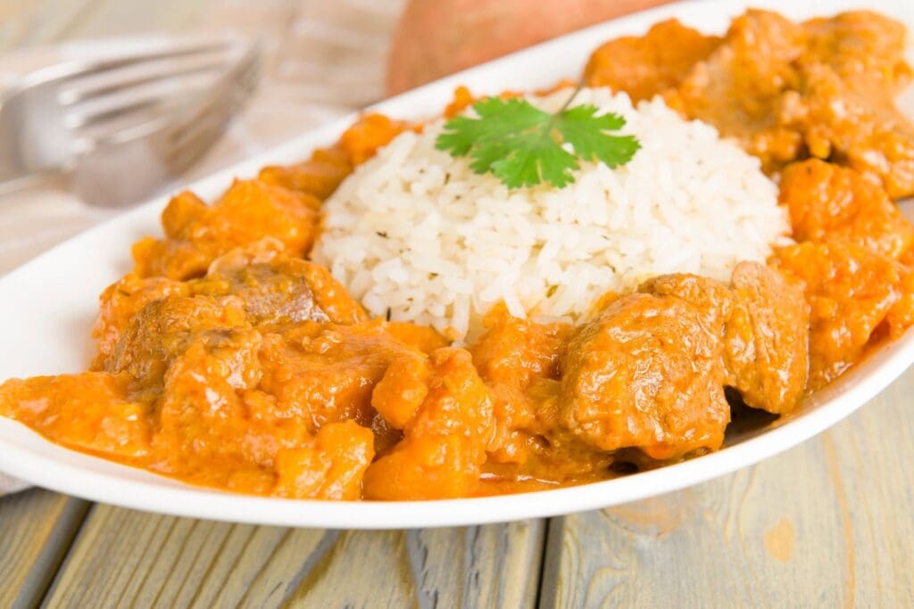 A plate of food with rice and meat on it.