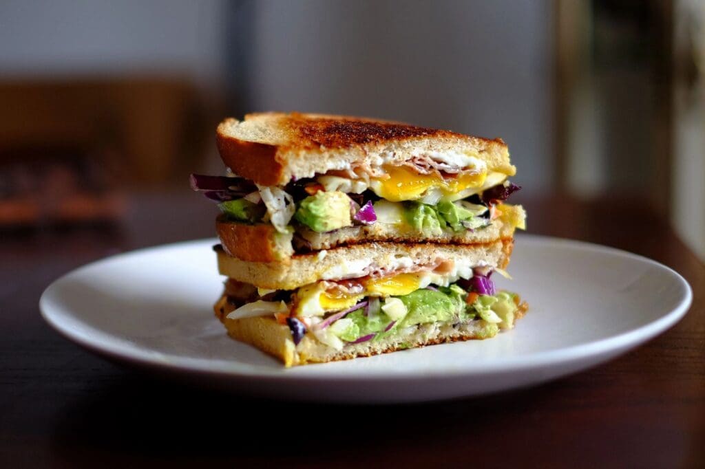 A sandwich cut in half on top of a plate.