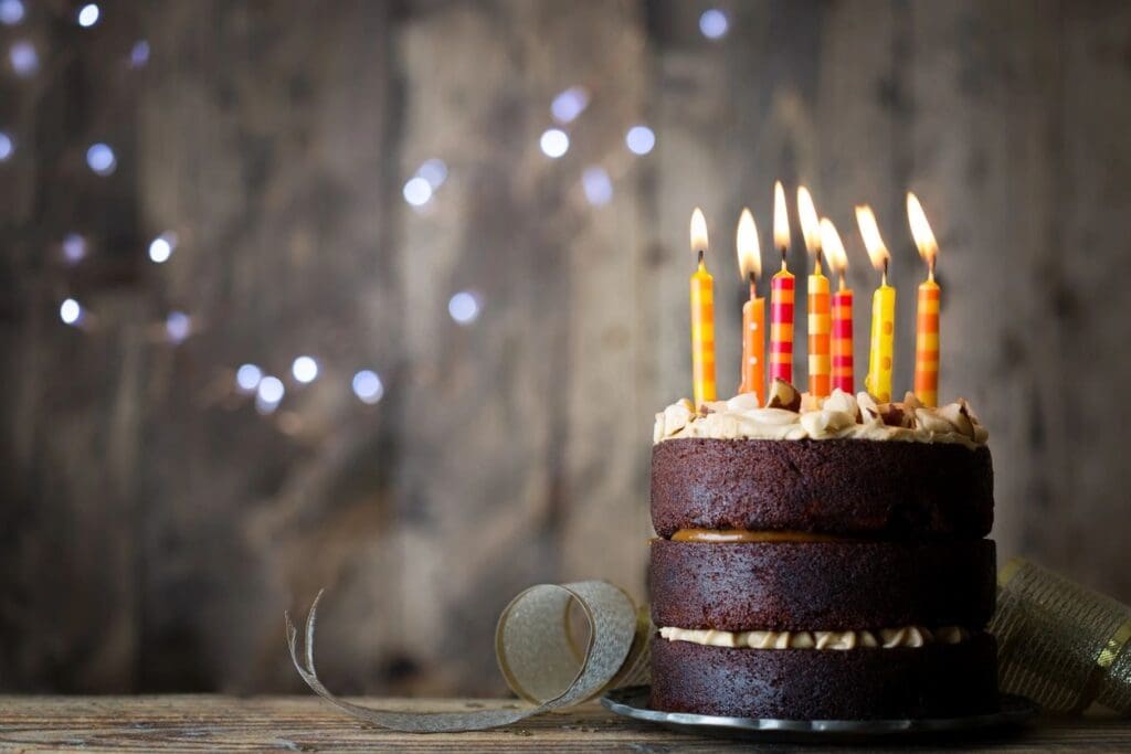 A cake with lit candles on top of it.