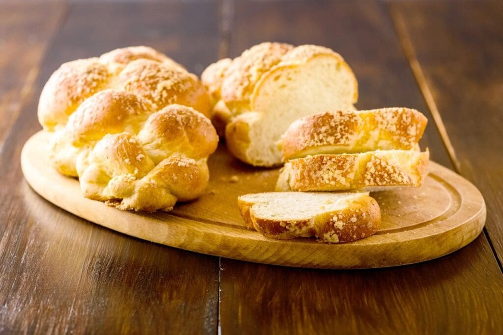 A wooden cutting board with some bread on it