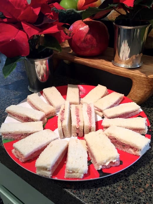 A red plate with sandwiches on it