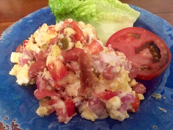 A blue plate with food on it and some lettuce