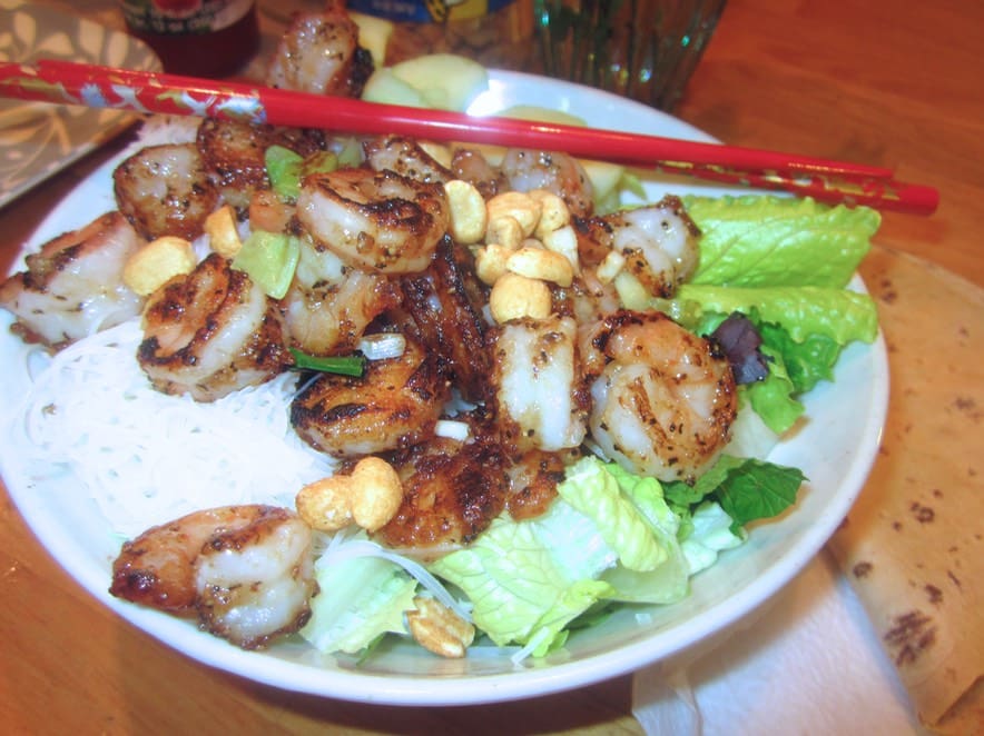 A plate of food with meat and corn on it.