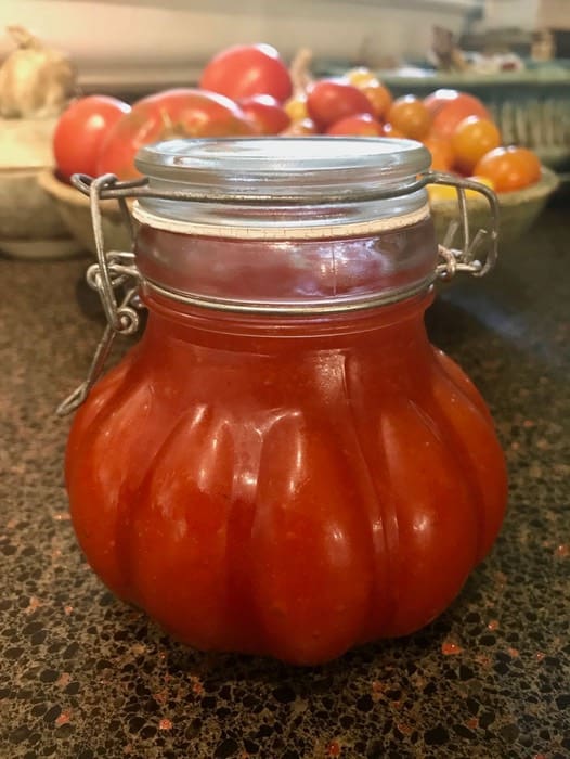 A jar of tomato sauce sitting on top of a table.