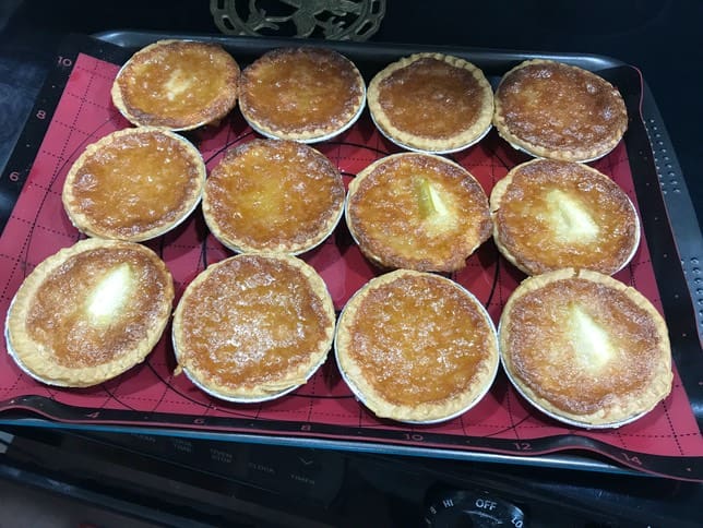 A tray of baked goods on top of the stove.