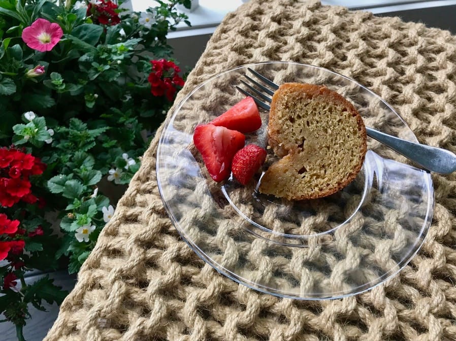 A plate with some strawberries and a piece of cake on it