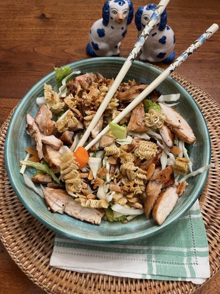 A bowl of food with chopsticks and chop sticks.