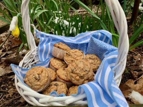 Basket of muffins on blue and white cloth.