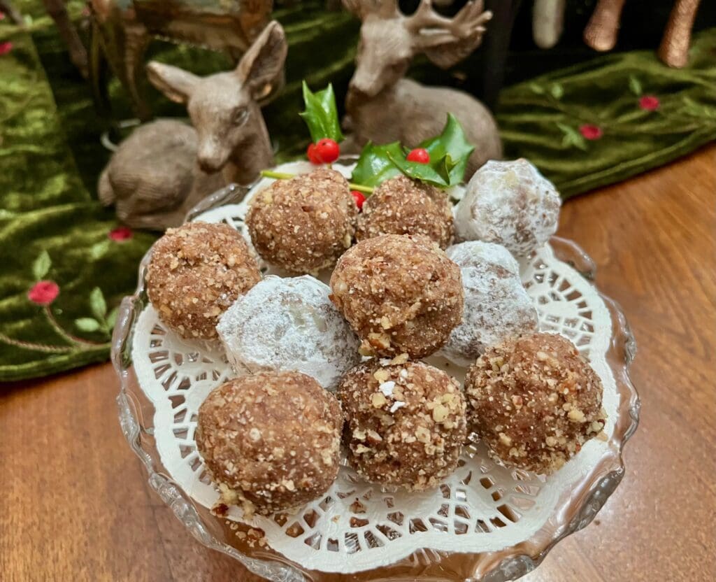 Chocolate-covered nut balls on a doily.