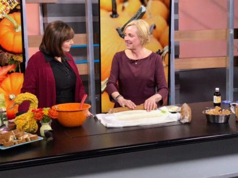 Two women baking in a kitchen studio.