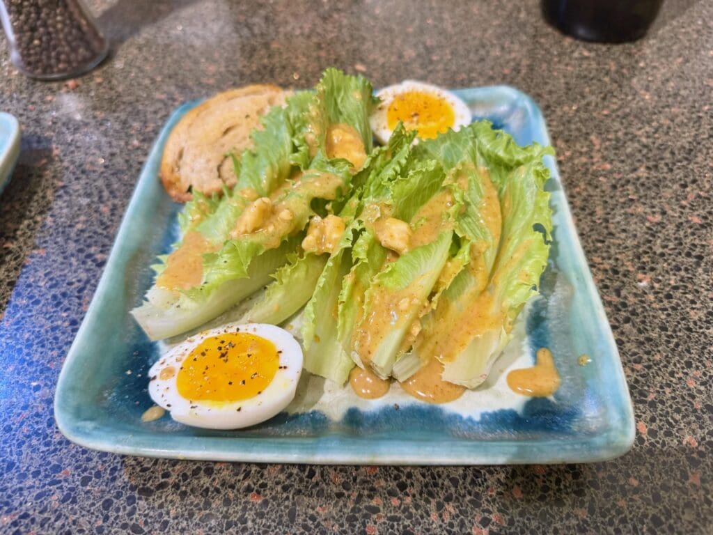 Salad with boiled eggs and dressing.
