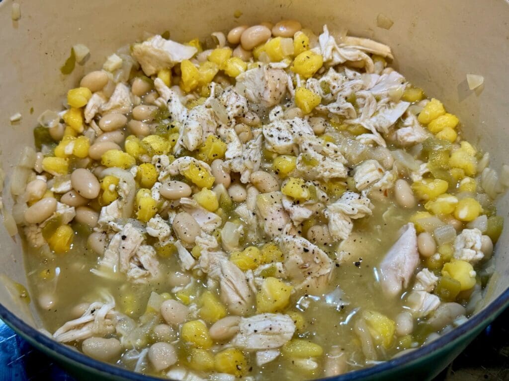 Chicken stew with beans and corn cooking.