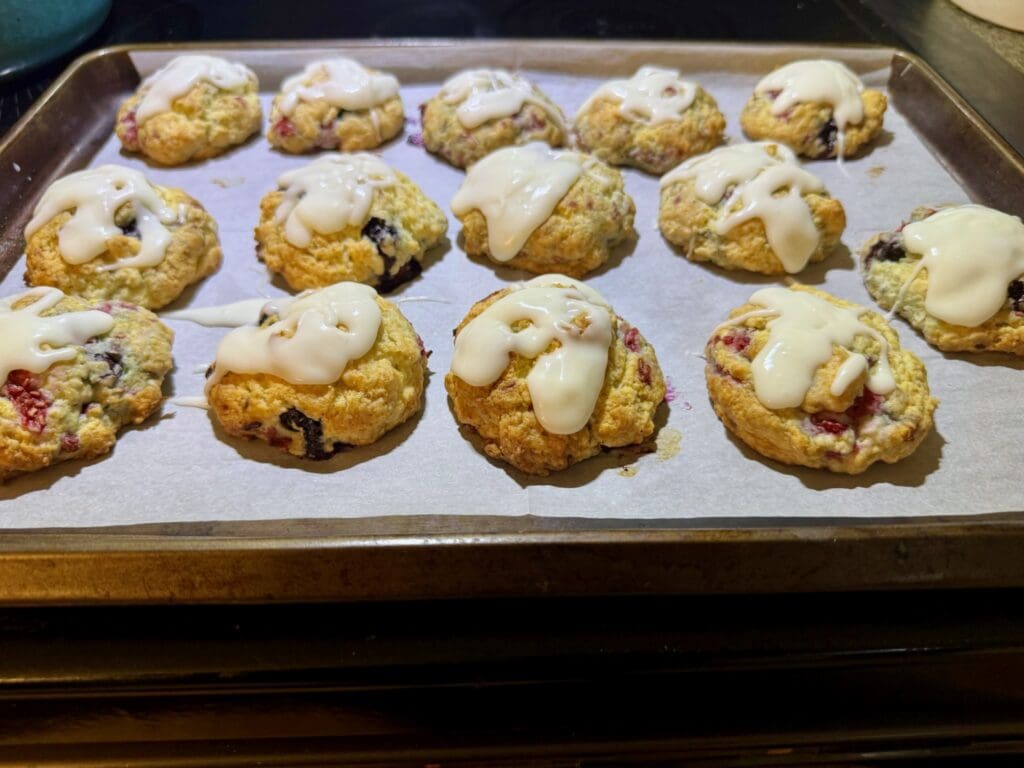 Cookies with icing on a baking sheet.