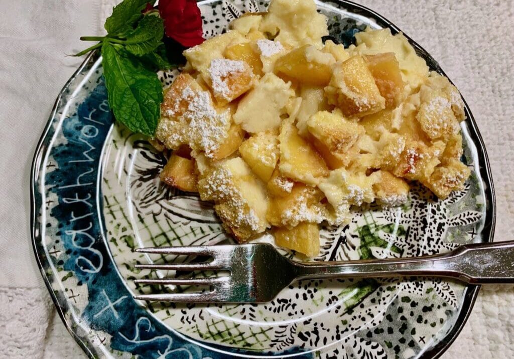 Peach cobbler on a patterned plate.