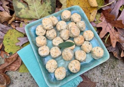 Savory biscuits on blue plate with leaves.