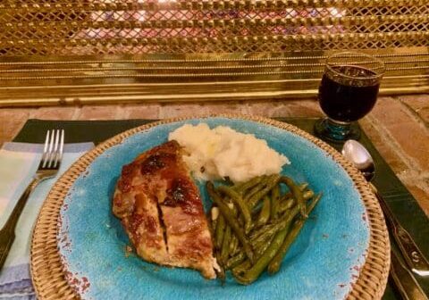 Roasted chicken with mashed potatoes and green beans.