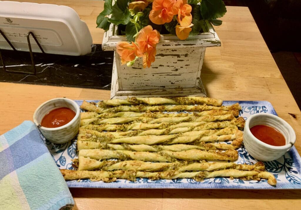 Pesto breadsticks with dipping sauce.