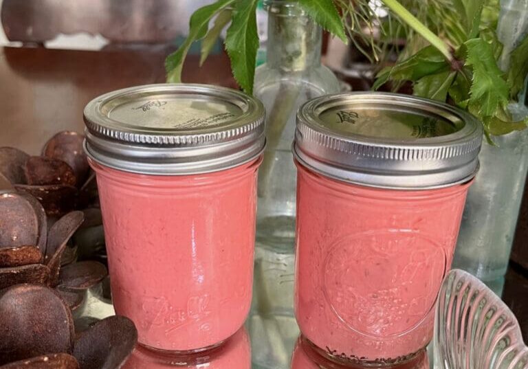 Pink jars of homemade salad dressing.