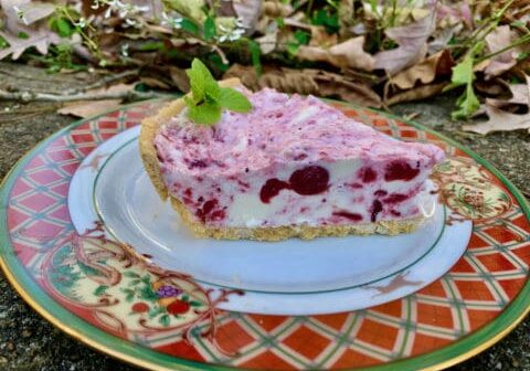 Slice of cherry cheesecake on a plate.