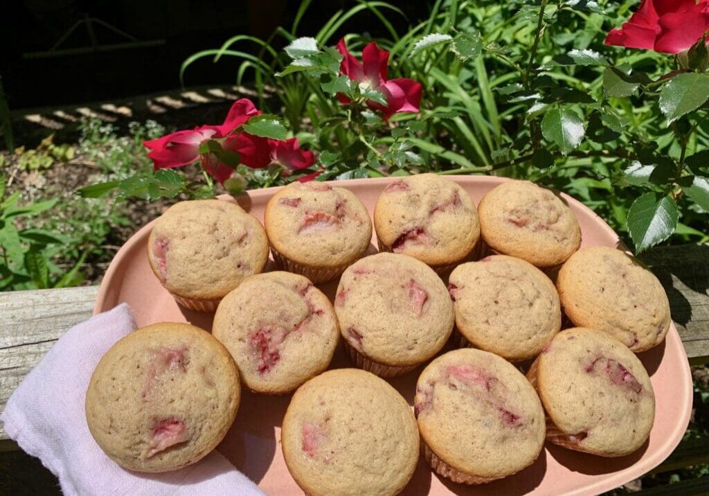 Strawberry muffins on a pink plate.