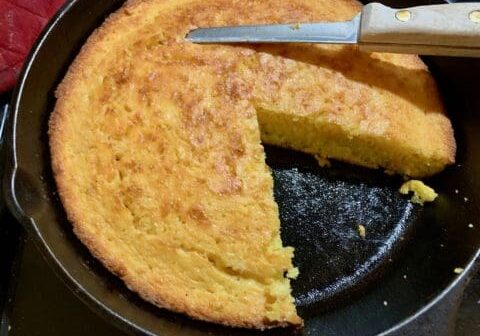 A slice of cornbread in a skillet.