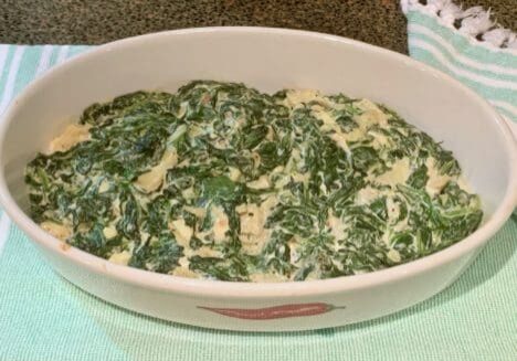 Creamed spinach in a white dish.