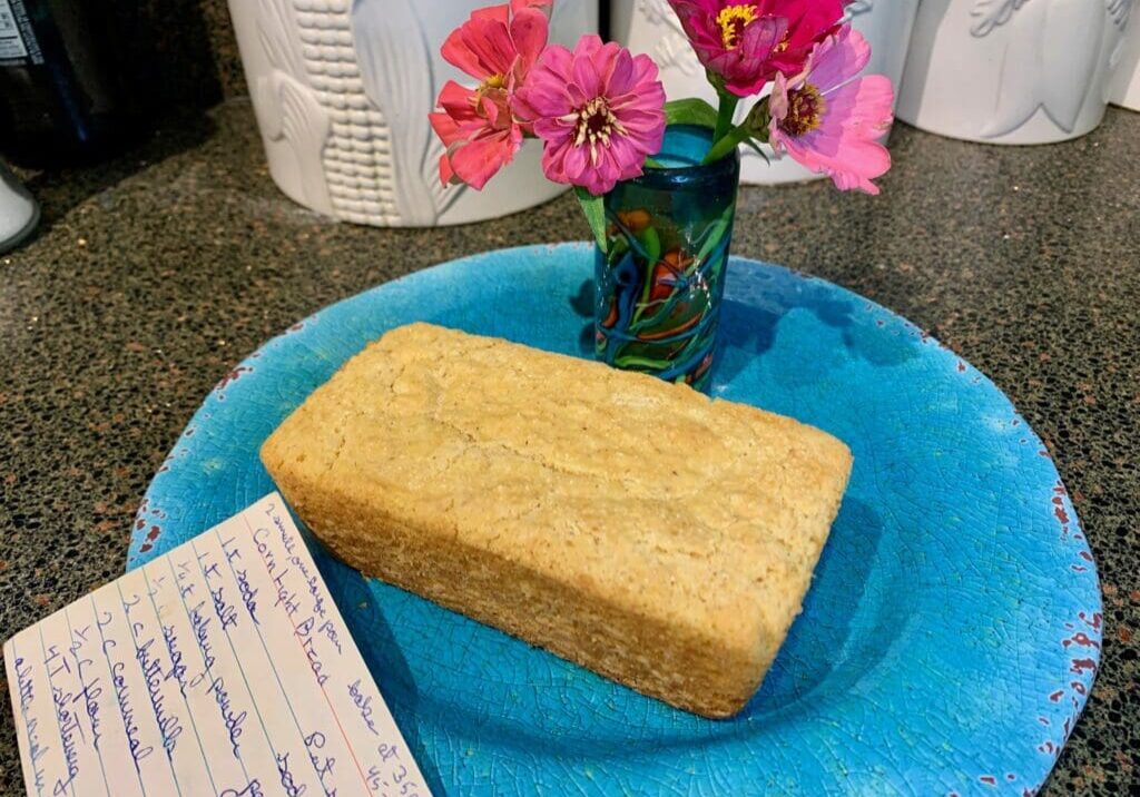 Cornbread loaf on a blue plate.