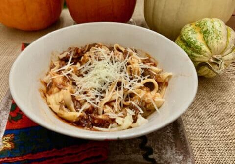 Pasta with meat sauce and parmesan cheese.