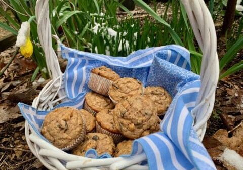 Basket of muffins on blue and white cloth.