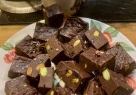 A plate of chocolate fudge with nuts.