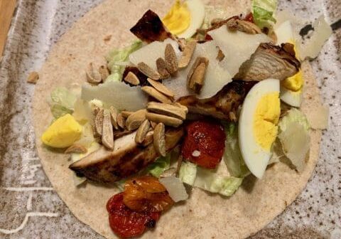 Chicken Caesar salad wrap with almonds.