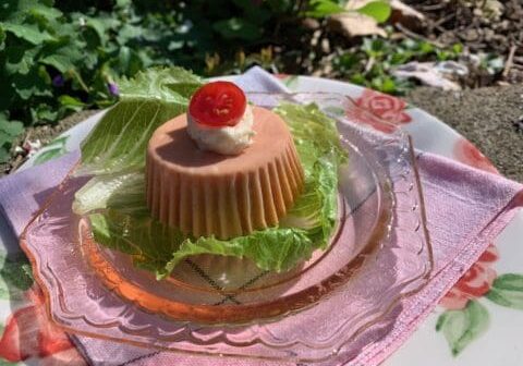 Pink dessert with lettuce on a plate.