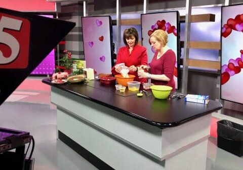 Two women baking in a kitchen studio.