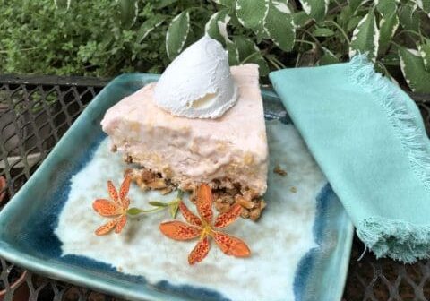 Ice cream pie on blue plate with flowers.