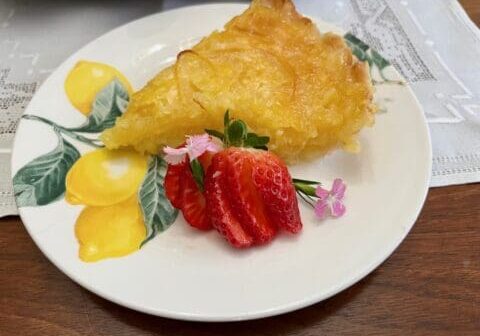 Lemon pie with strawberries on a plate.