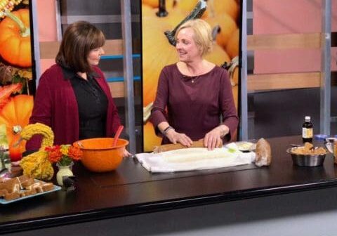 Two women baking in a kitchen studio.