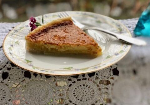 Slice of golden brown pie on plate.