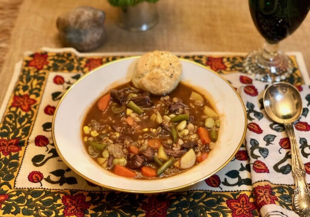 Bowl of beef barley soup with bread