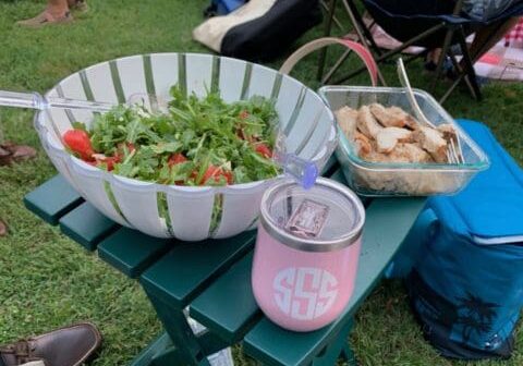 Salad, chicken, and a pink tumbler.