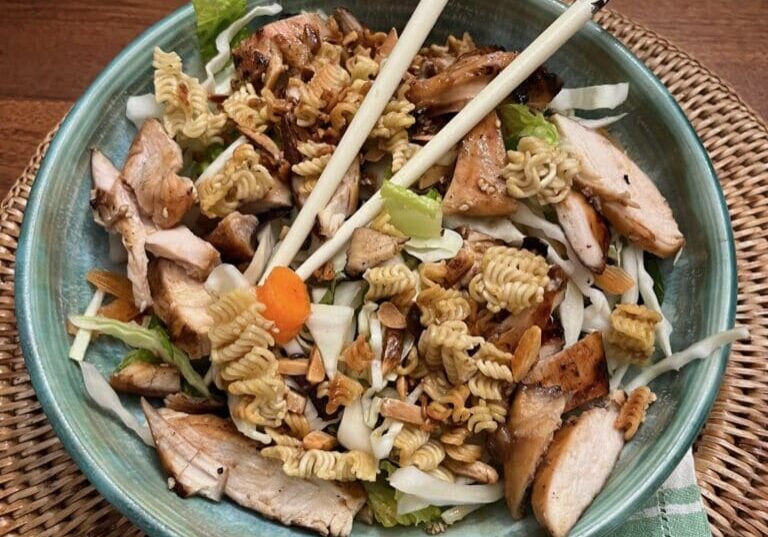 A bowl of food with chopsticks and chop sticks.