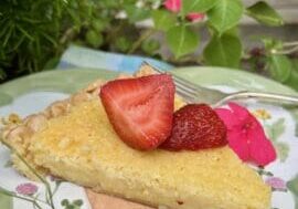 Slice of lemon pie with strawberries.