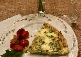 Slice of spinach and feta frittata on a plate.