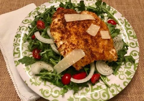 Crispy fish with arugula salad and cheese.