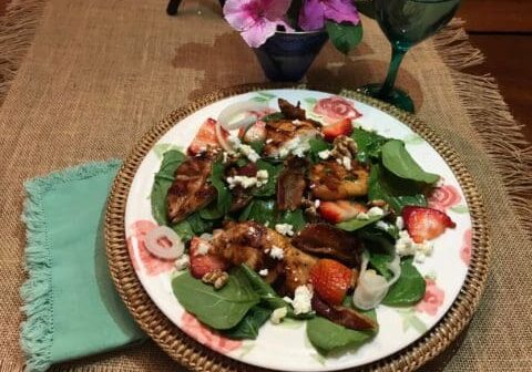 Chicken and spinach salad with strawberries.